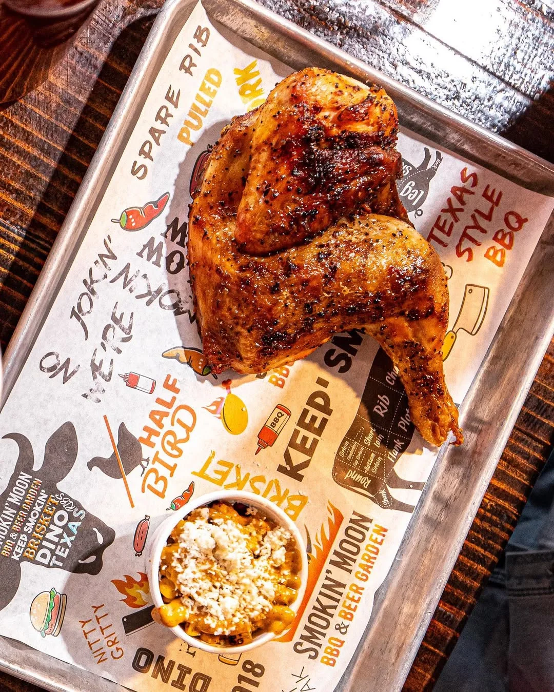 Half chicken on Smokin’ Moon BBQ illustrated tray paper